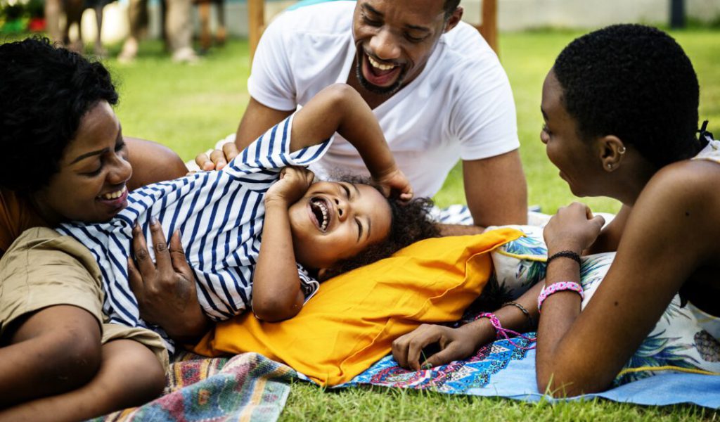 Black family enjoying summer together at backyard